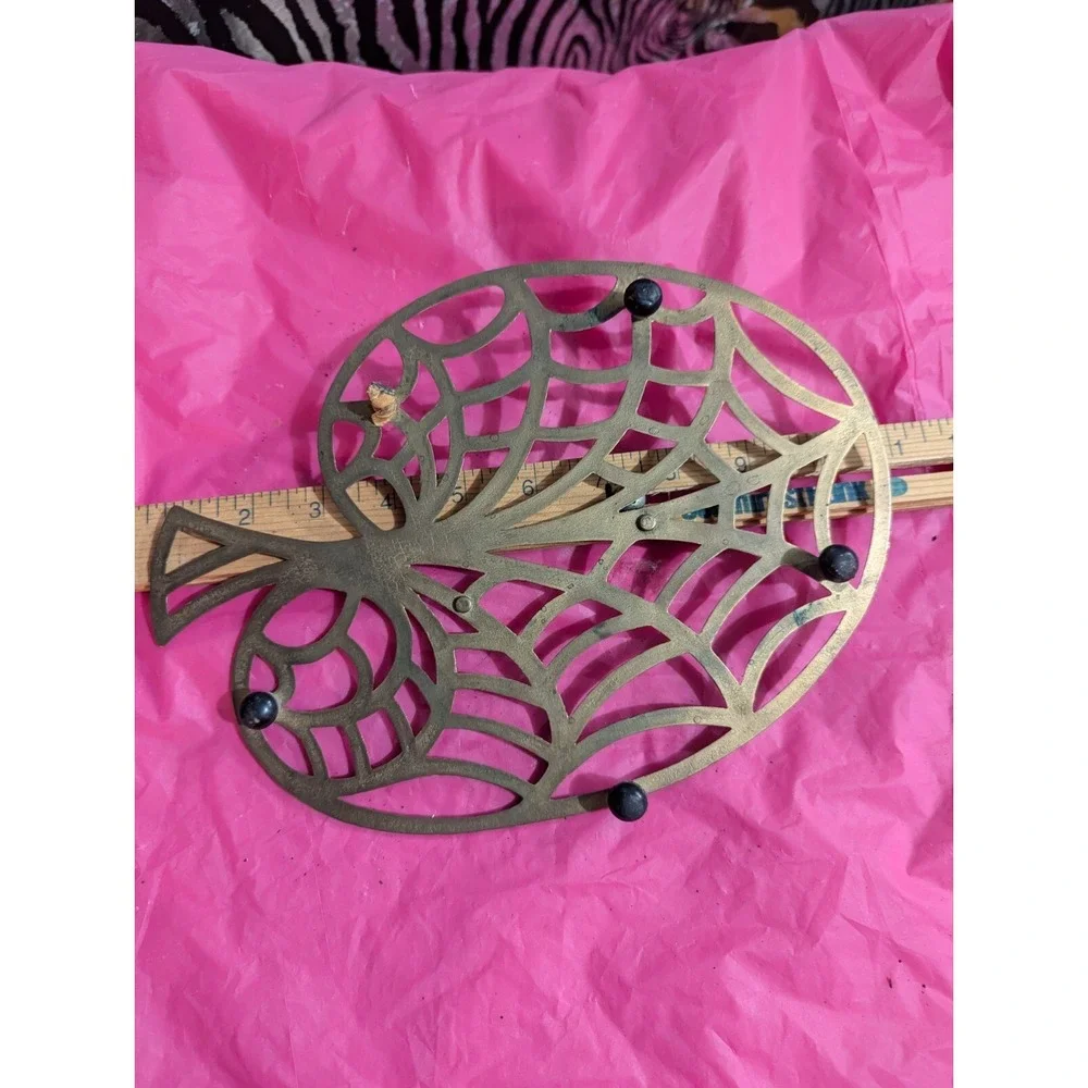 Brass color larger trivet web looking leaf tree ?